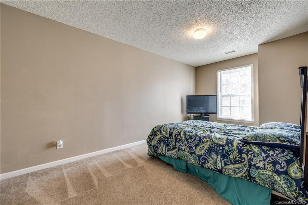 8808 Old Potters Road Charlotte, NC 28269 - Photo 27 of 34 a bedroom with a bed and a window