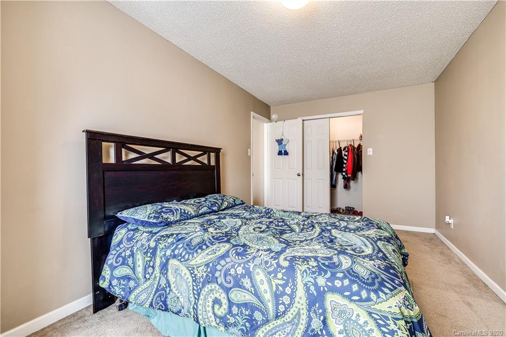 8808 Old Potters Road Charlotte, NC 28269 - Photo 28 of 34 a bedroom with a bed and a dresser
