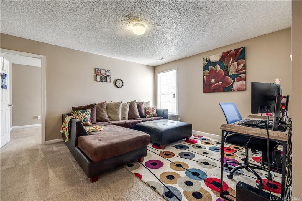 8808 Old Potters Road Charlotte, NC 28269 - Photo 29 of 34 a living room with furniture and a flat screen tv