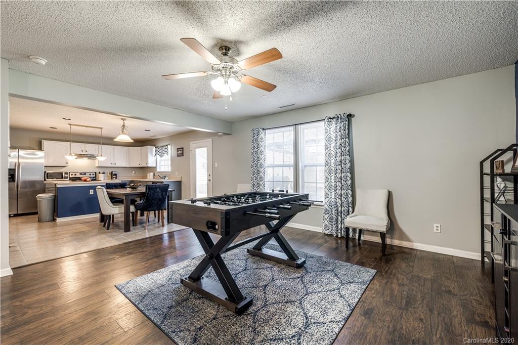 8808 Old Potters Road Charlotte, NC 28269 - Photo 8 of 34 a living room with furniture a wooden floor and chandelier