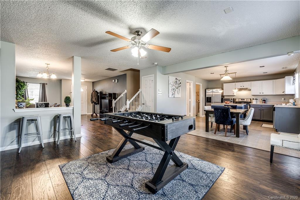 8808 Old Potters Road Charlotte, NC 28269 - Photo 9 of 34 a living room with lots of furniture a table and chairs