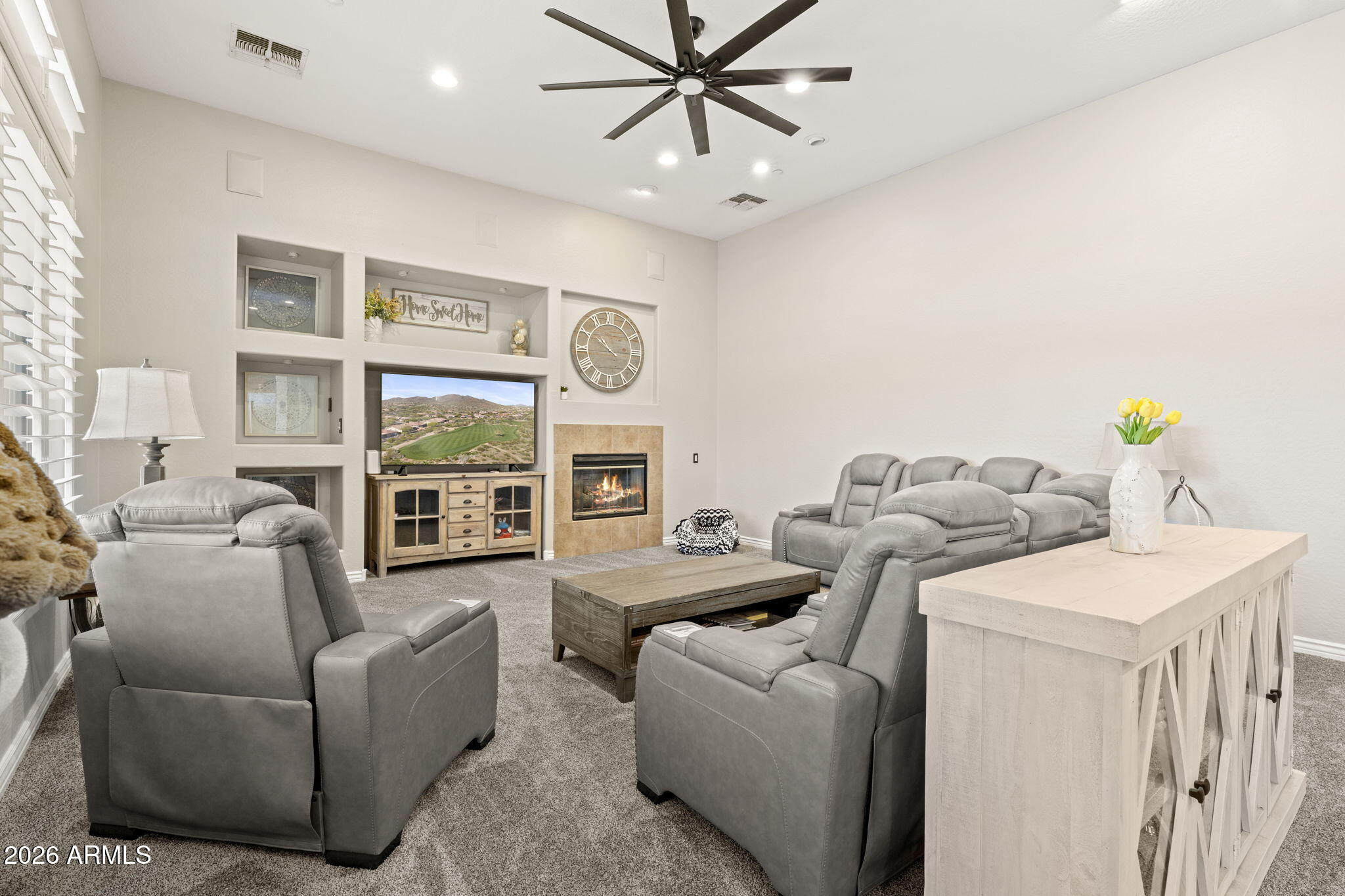41619 North River Bend Road Anthem, AZ 85086 - Photo 45 of 84 a living room with furniture a fireplace and a chandelier