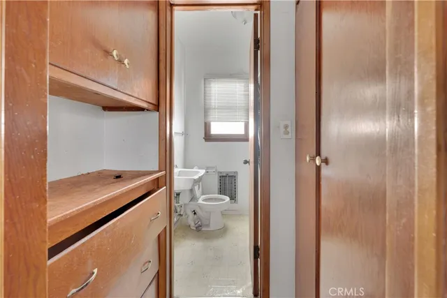 a bathroom with a granite countertop toilet and a shower