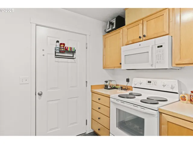 a kitchen with a sink a stove and cabinets