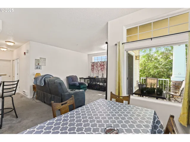 a living room with furniture a large window and chair