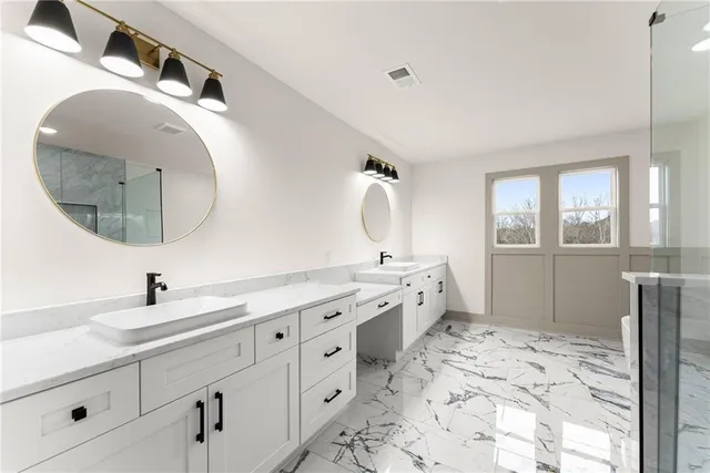 a spacious bathroom with a double vanity sink mirror and