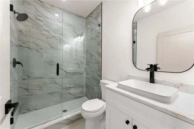 a bathroom with a sink toilet and shower
