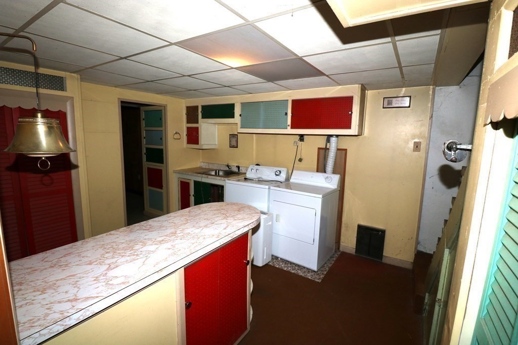 118 Merrimac Avenue Springfield, MA 01104 - Photo 19 of 20 a kitchen with stainless steel appliances kitchen island granite countertop a refrigerator and a stove top oven