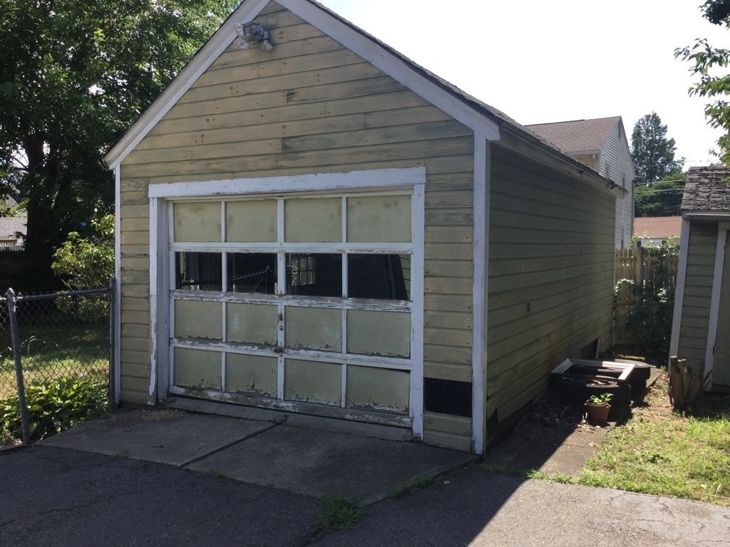 118 Merrimac Avenue Springfield, MA 01104 - Photo 4 of 20 a front view of a house with a garden