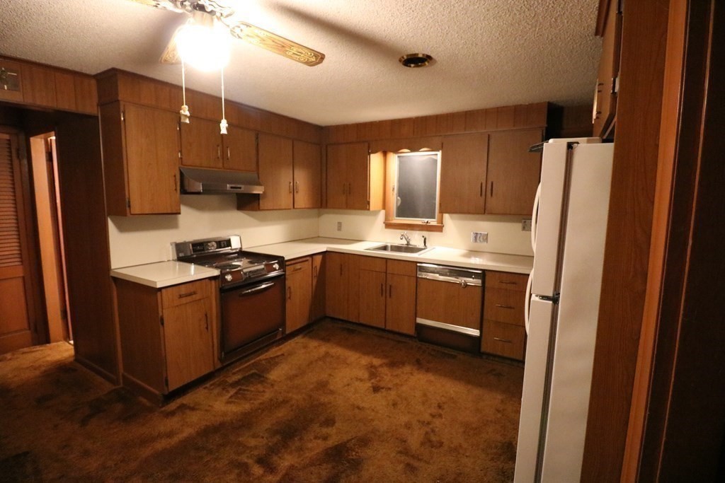 118 Merrimac Avenue Springfield, MA 01104 - Photo 6 of 20 a kitchen with stainless steel appliances granite countertop a stove a refrigerator and a sink