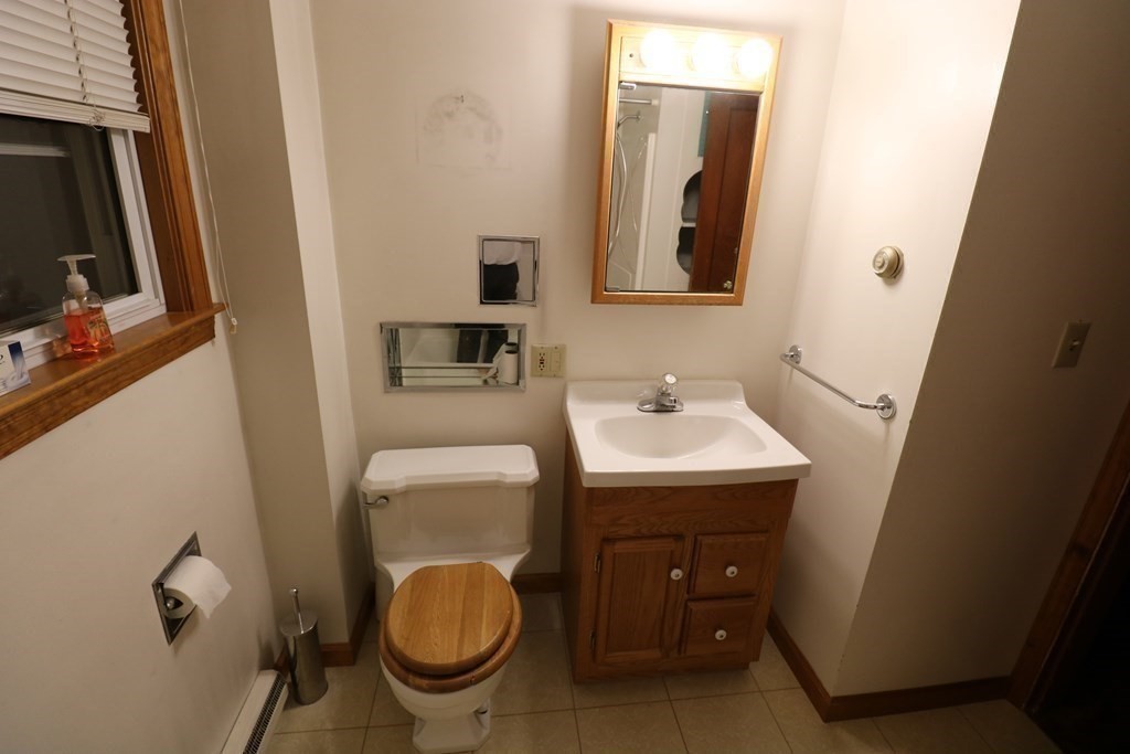 118 Merrimac Avenue Springfield, MA 01104 - Photo 7 of 20 a bathroom with a toilet a sink and mirror