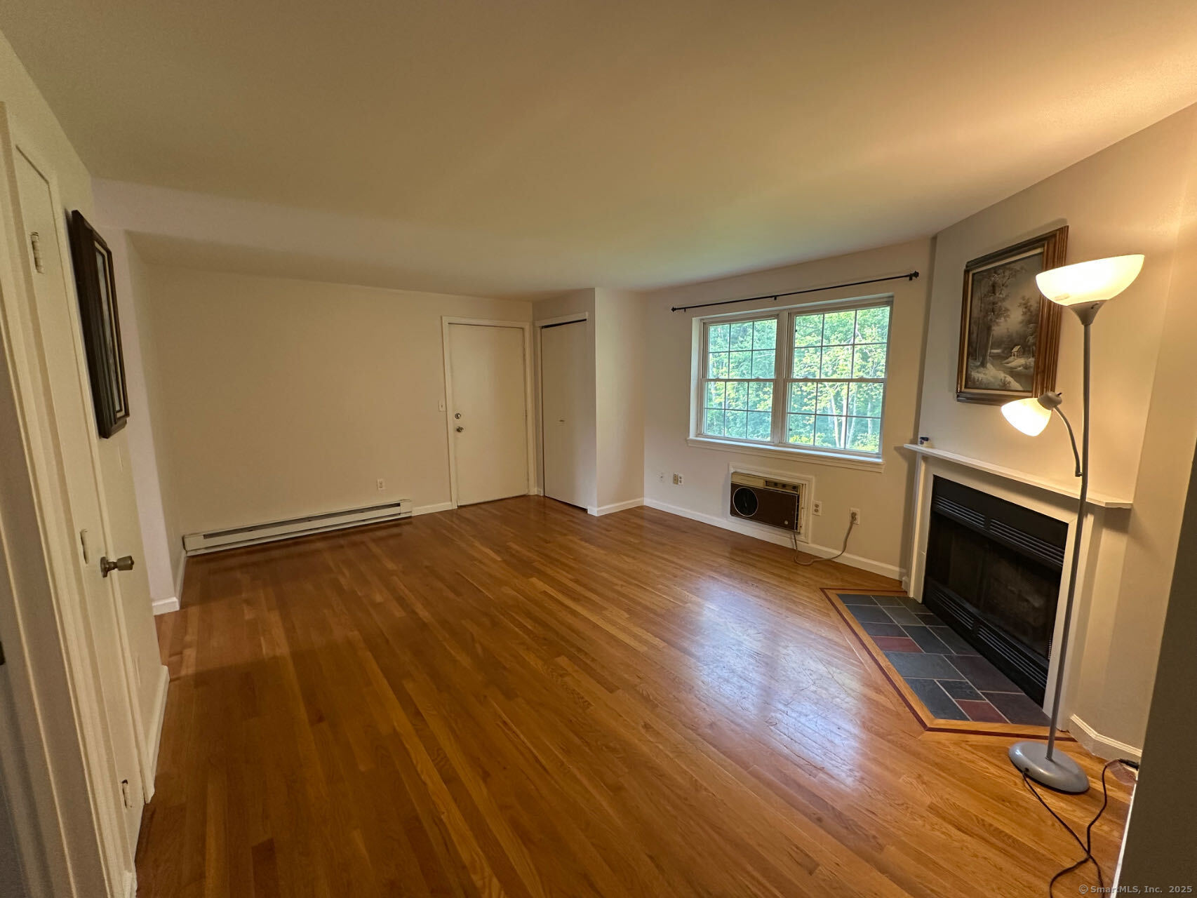 45 Crystal Lane, Unit D Mansfield, CT 06268 - Photo 3 of 11 a view of empty room with wooden floor and fireplace