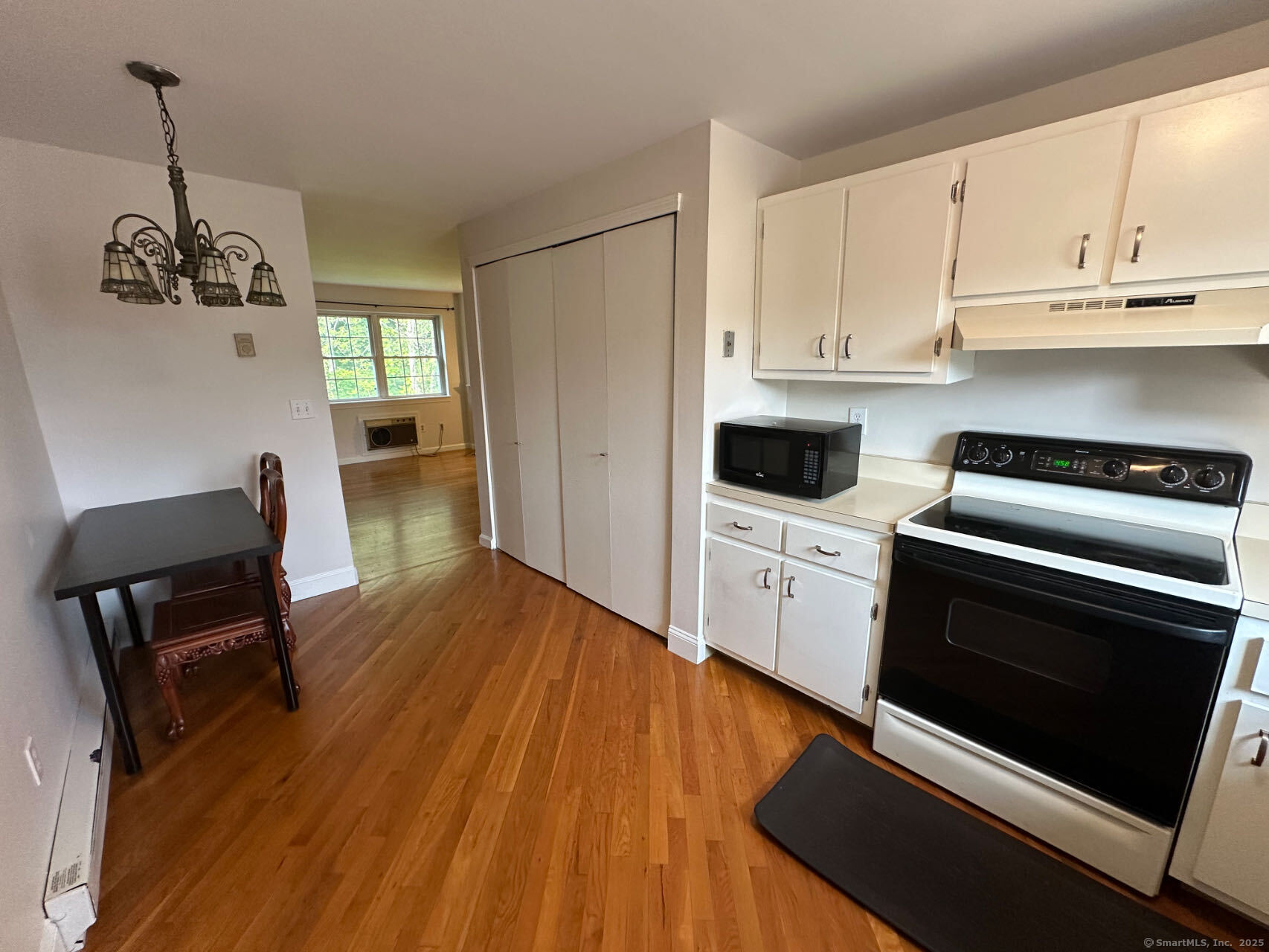 45 Crystal Lane, Unit D Mansfield, CT 06268 - Photo 7 of 11 a kitchen with wooden floors and appliances