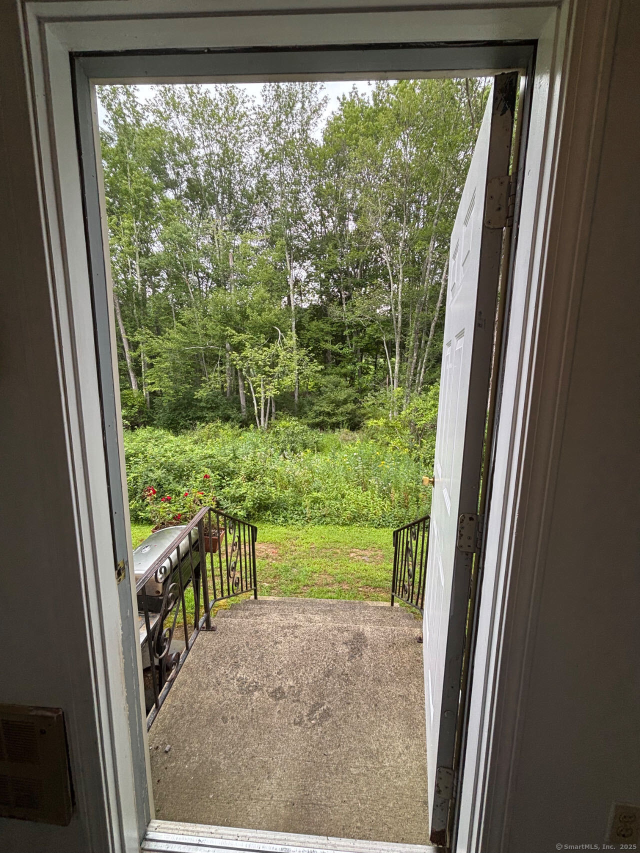 45 Crystal Lane, Unit D Mansfield, CT 06268 - Photo 10 of 11 a view of a porch and floor to ceiling window