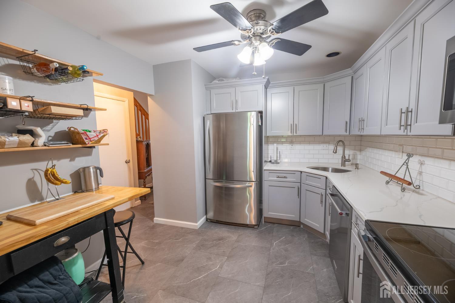 13 Mine Road Jamesburg, NJ 08831 - Photo 18 of 52 a kitchen with a refrigerator a sink cabinets and appliances