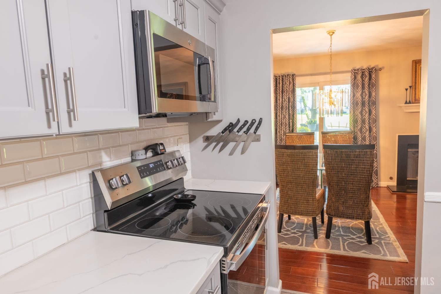 13 Mine Road Jamesburg, NJ 08831 - Photo 20 of 52 a kitchen with a stove a sink and a refrigerator