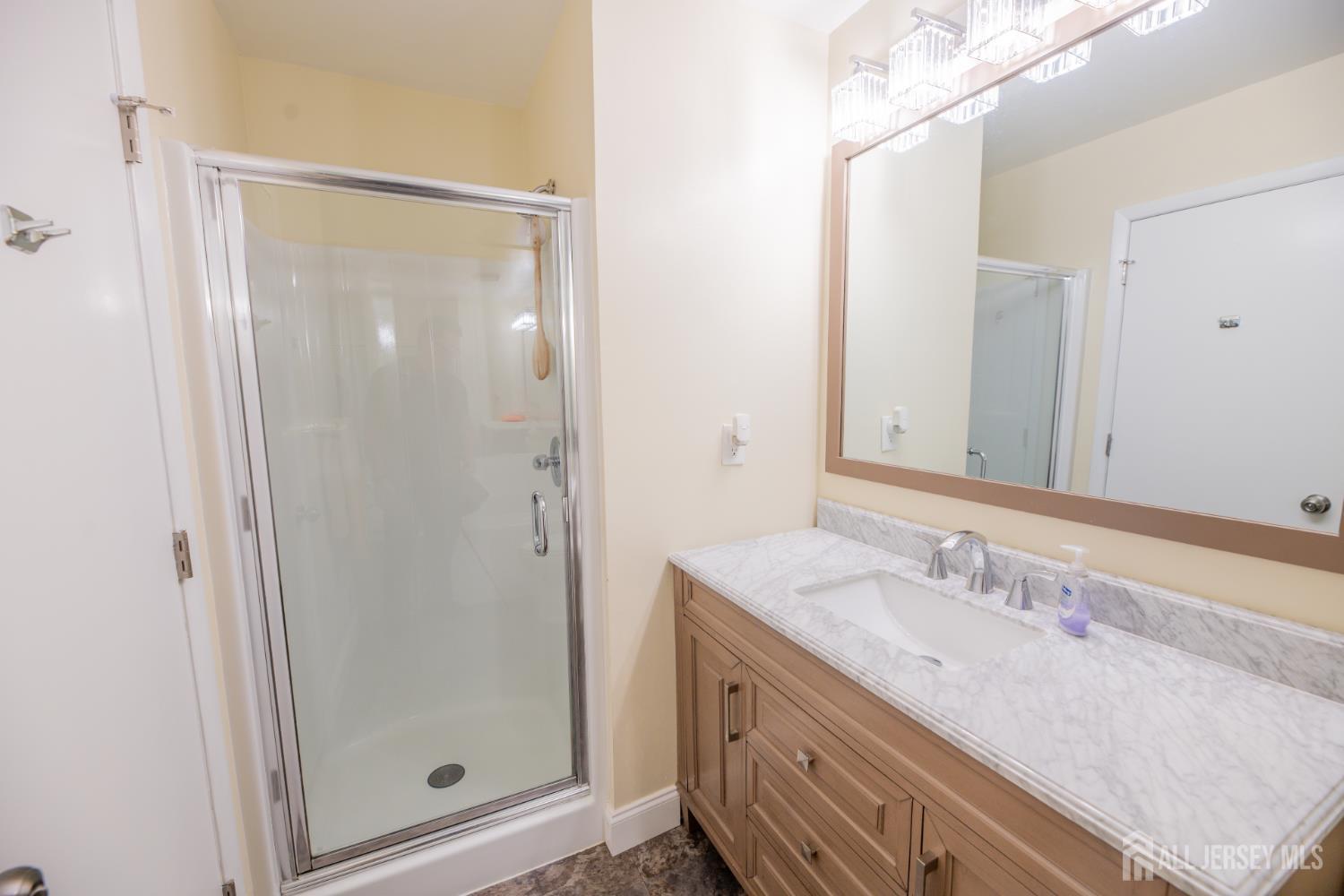 13 Mine Road Jamesburg, NJ 08831 - Photo 33 of 52 a bathroom with a granite countertop shower sink and mirror
