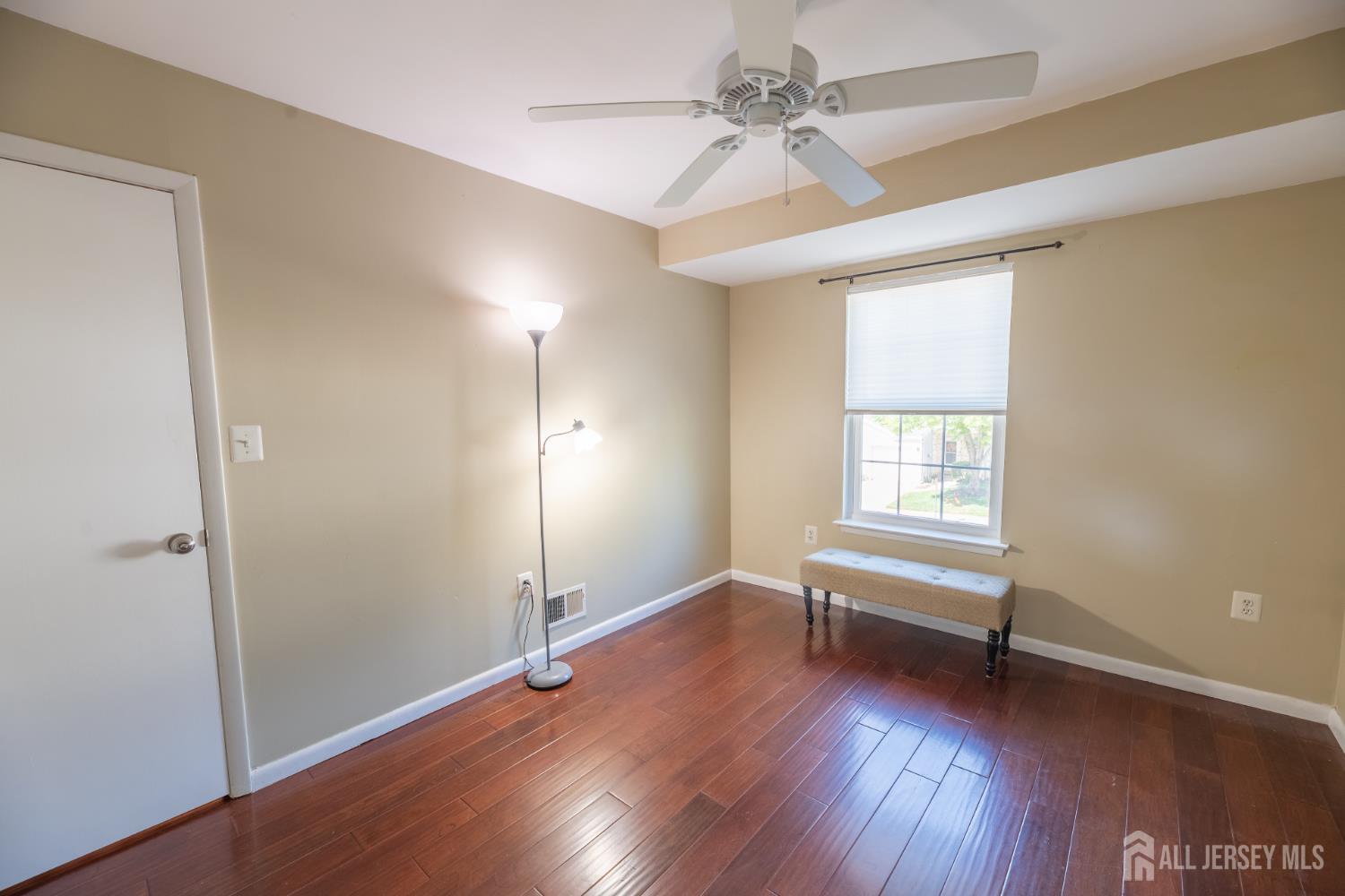 13 Mine Road Jamesburg, NJ 08831 - Photo 35 of 52 an empty room with wooden floor and windows