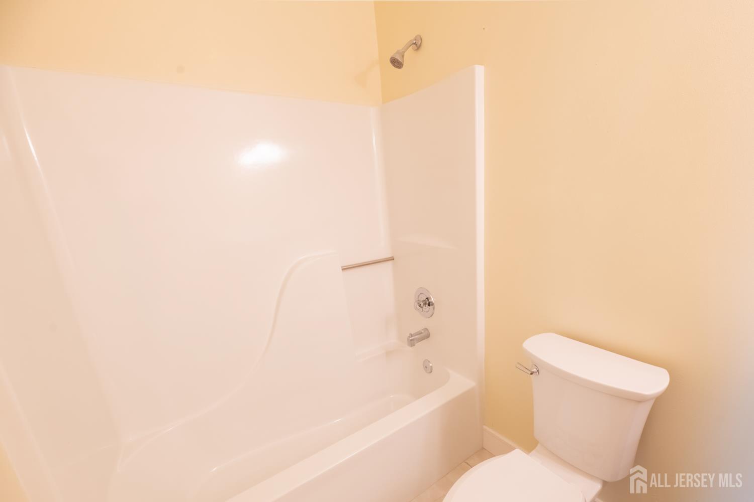 13 Mine Road Jamesburg, NJ 08831 - Photo 41 of 52 a white toilet sitting next to a bath tub