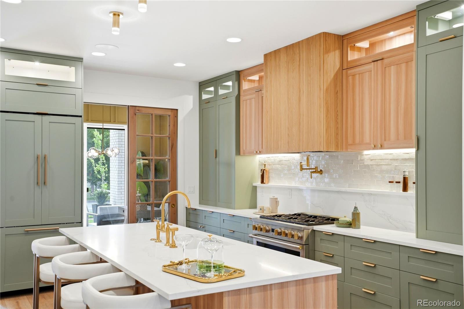 245 South Emerson Street Denver, CO 80209 - Photo 15 of 49 a kitchen with a table chairs stove and cabinets