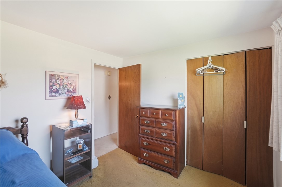 6225 Possum Run Road Bellbrook, OH 45305 - Photo 27 of 33 This cozy bedroom features warm wooden accents, offering a comfortable and inviting retreat.