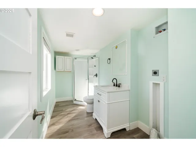 a bathroom with a sink a toilet and a mirror