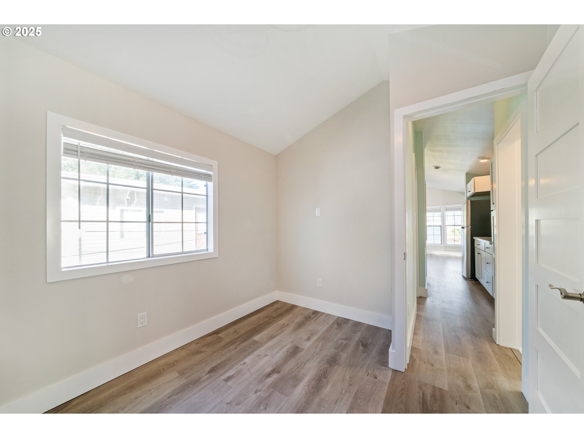 37000 Tohl Ranch Road, Unit 29 Nehalem, OR 97131 - Photo 19 of 46 an empty room with wooden floor and a window