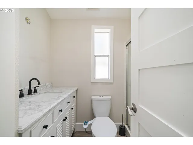 a bathroom with a sink toilet and a mirror