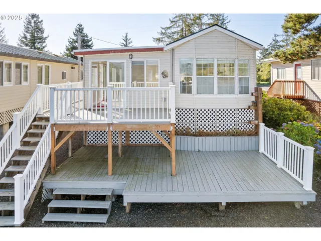 a view of a house with a wooden deck