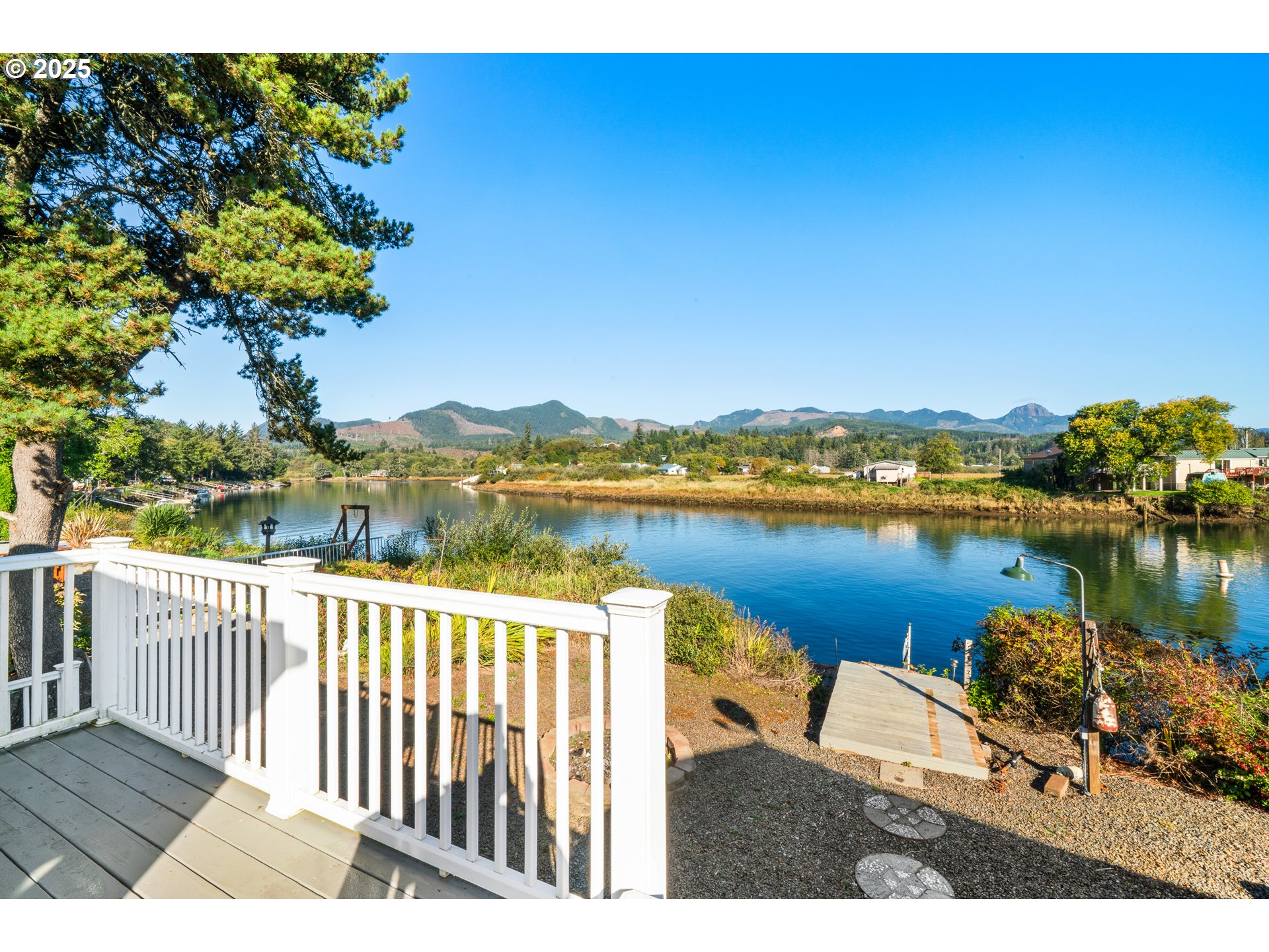 37000 Tohl Ranch Road, Unit 29 Nehalem, OR 97131 - Photo 22 of 46 a view of a lake with a city from a balcony