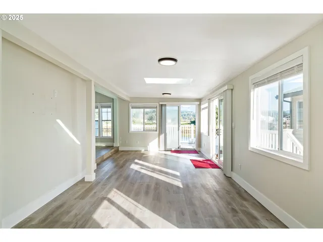 a living room with hardwood flooring and windows