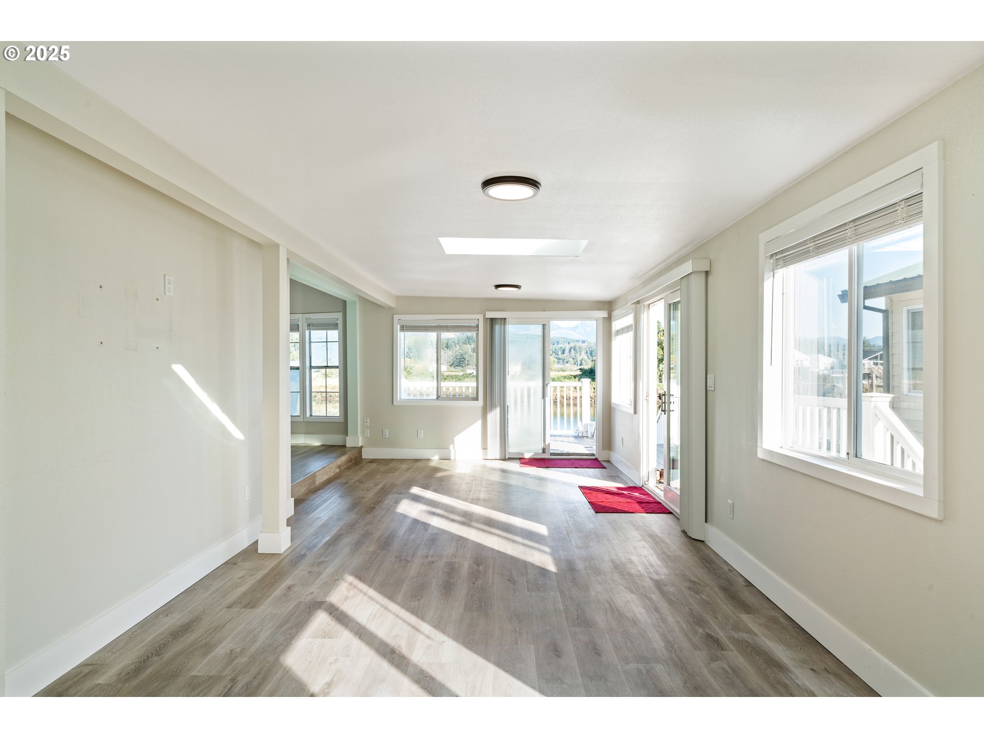 37000 Tohl Ranch Road, Unit 29 Nehalem, OR 97131 - Photo 4 of 46 a living room with hardwood flooring and windows