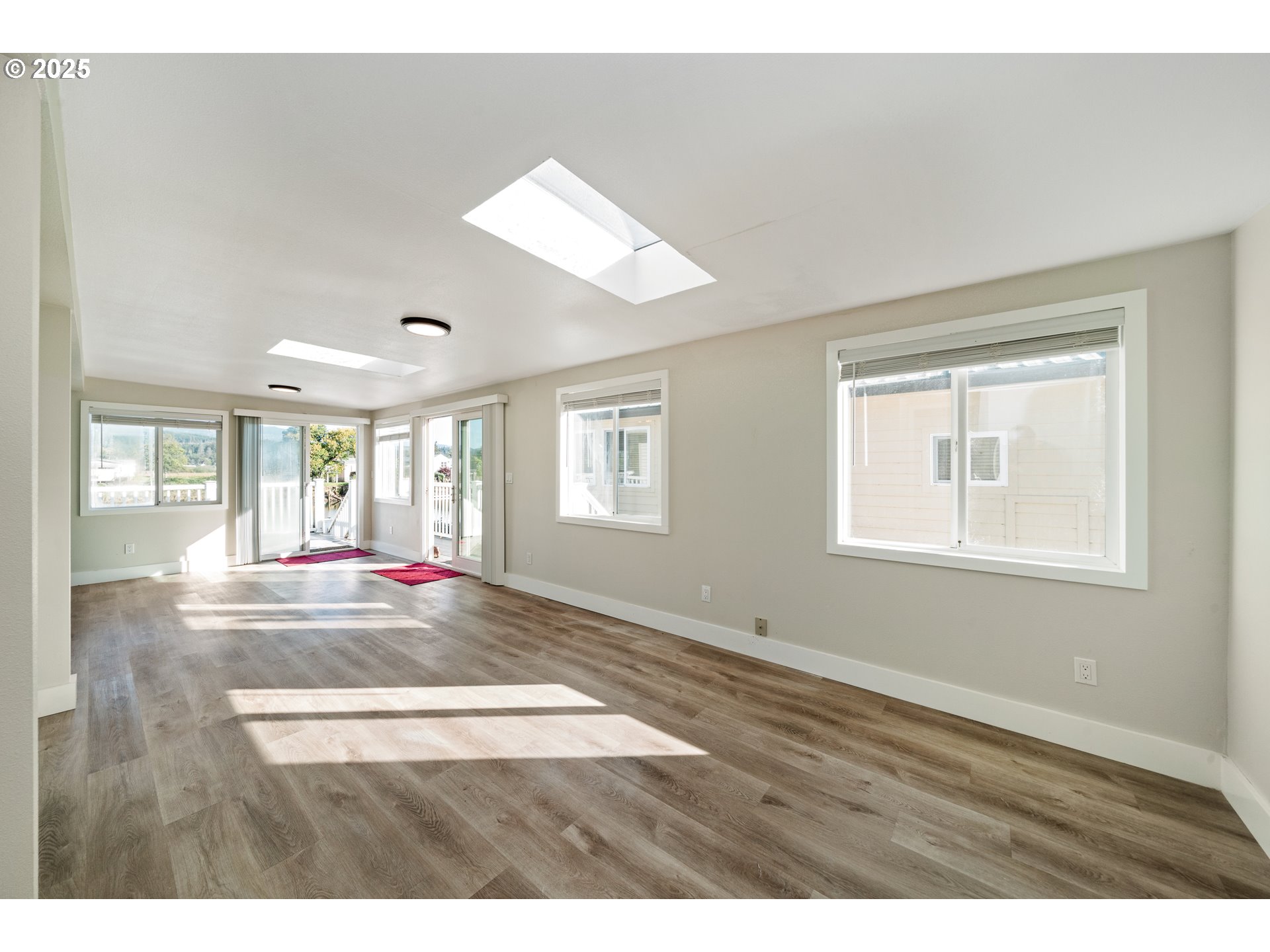 37000 Tohl Ranch Road, Unit 29 Nehalem, OR 97131 - Photo 5 of 46 a view of an empty room with wooden floor and a window