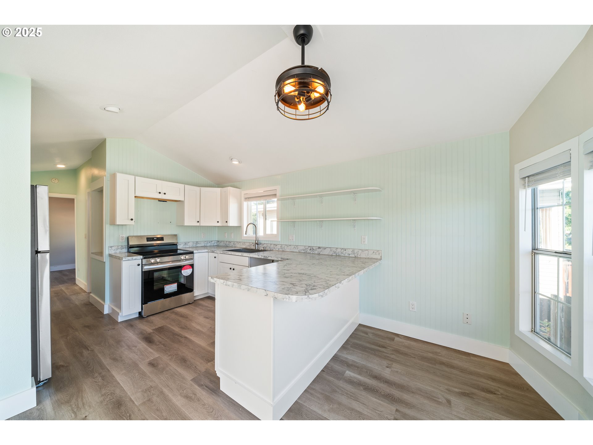 37000 Tohl Ranch Road, Unit 29 Nehalem, OR 97131 - Photo 7 of 46 a kitchen with stainless steel appliances granite countertop a stove a sink and a wooden floors