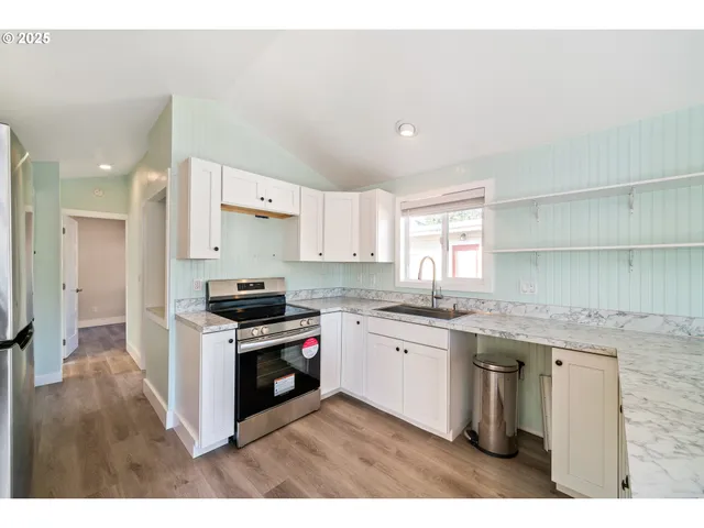 a kitchen with stainless steel appliances granite countertop a stove and a sink