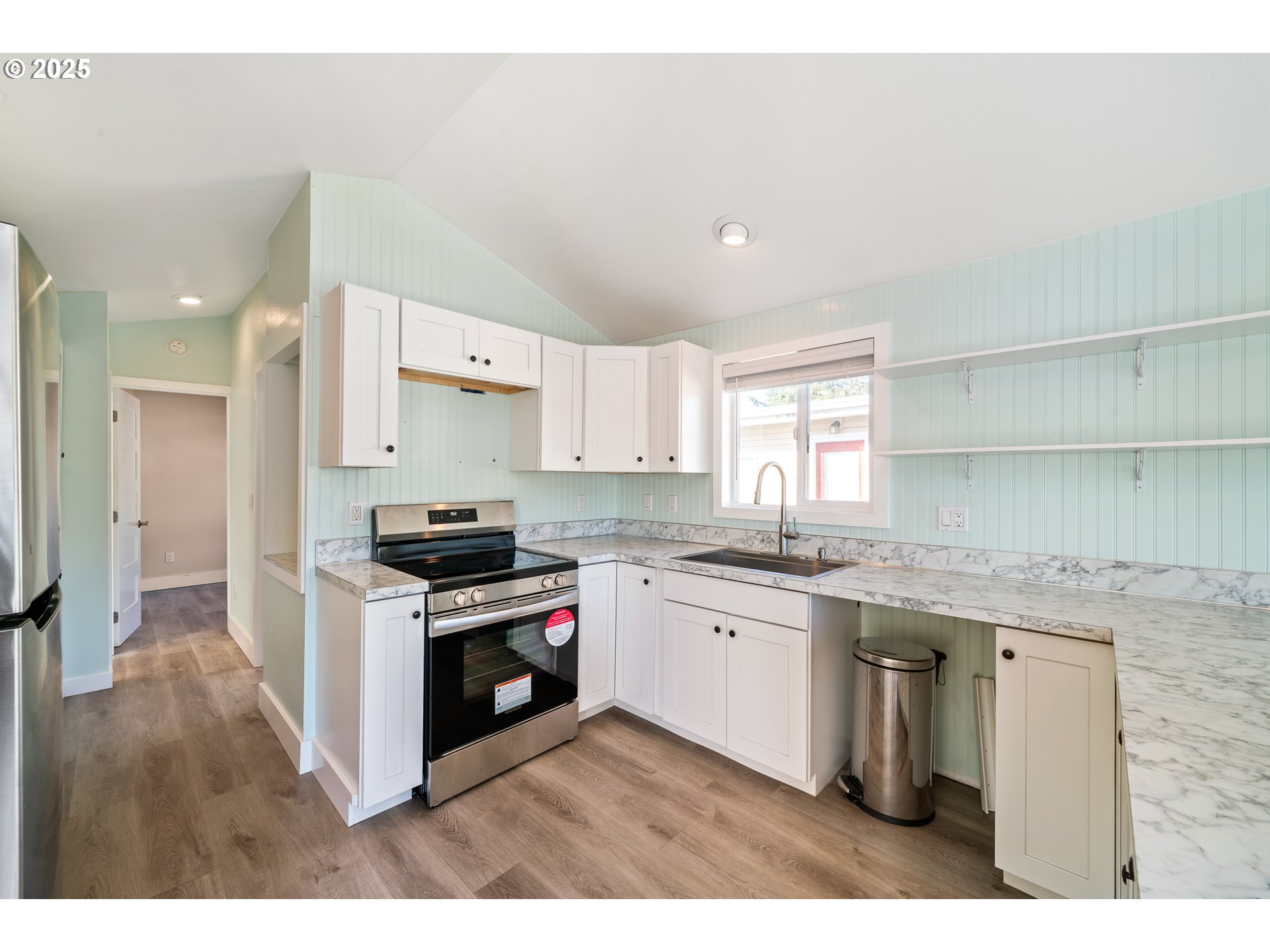 37000 Tohl Ranch Road, Unit 29 Nehalem, OR 97131 - Photo 9 of 46 a kitchen with stainless steel appliances granite countertop a stove and a sink