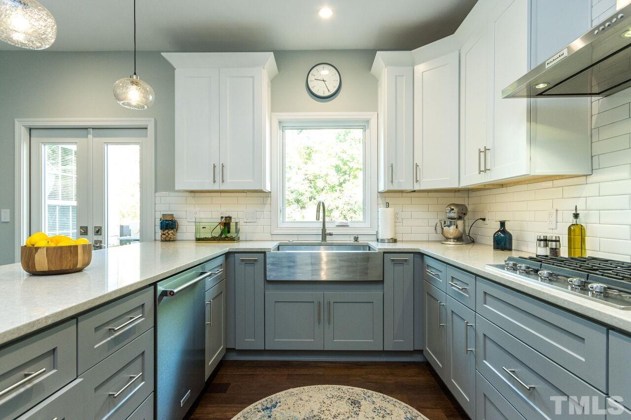 8215 Oneal Road Raleigh, NC 27613 - Photo 11 of 23 a kitchen with a sink cabinets and window