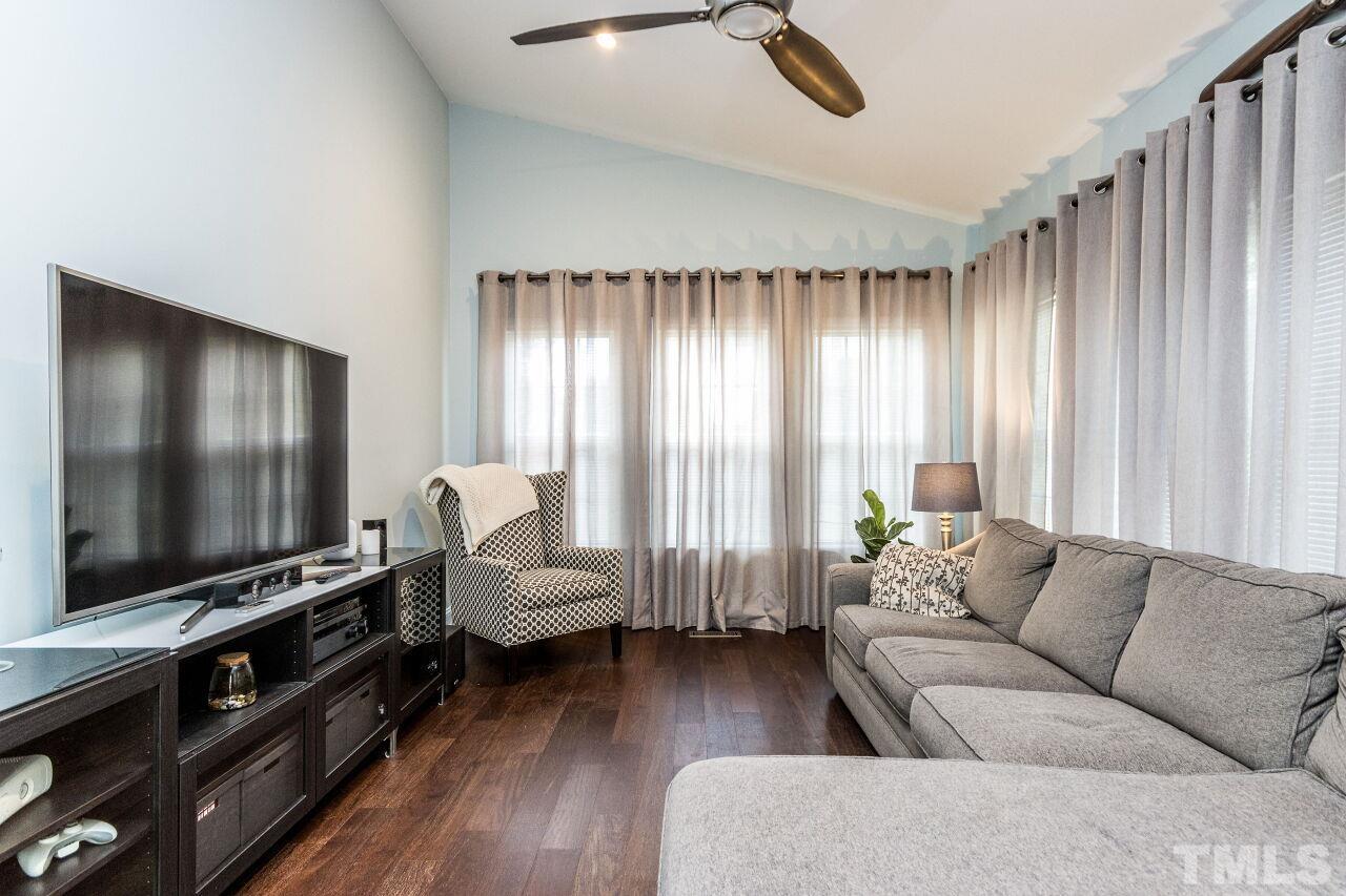 8215 Oneal Road Raleigh, NC 27613 - Photo 12 of 23 a living room with furniture and a flat screen tv