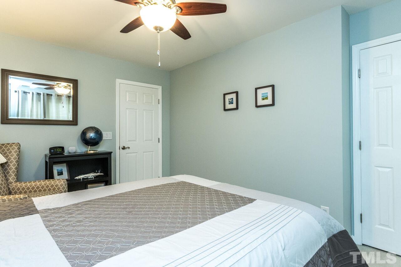8215 Oneal Road Raleigh, NC 27613 - Photo 17 of 23 a bedroom with a bed and a table