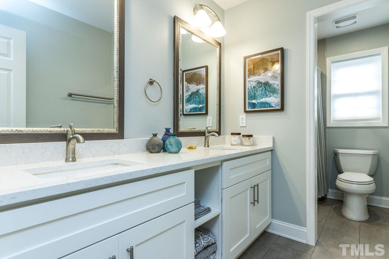 8215 Oneal Road Raleigh, NC 27613 - Photo 18 of 23 a bathroom with a toilet sink and mirror