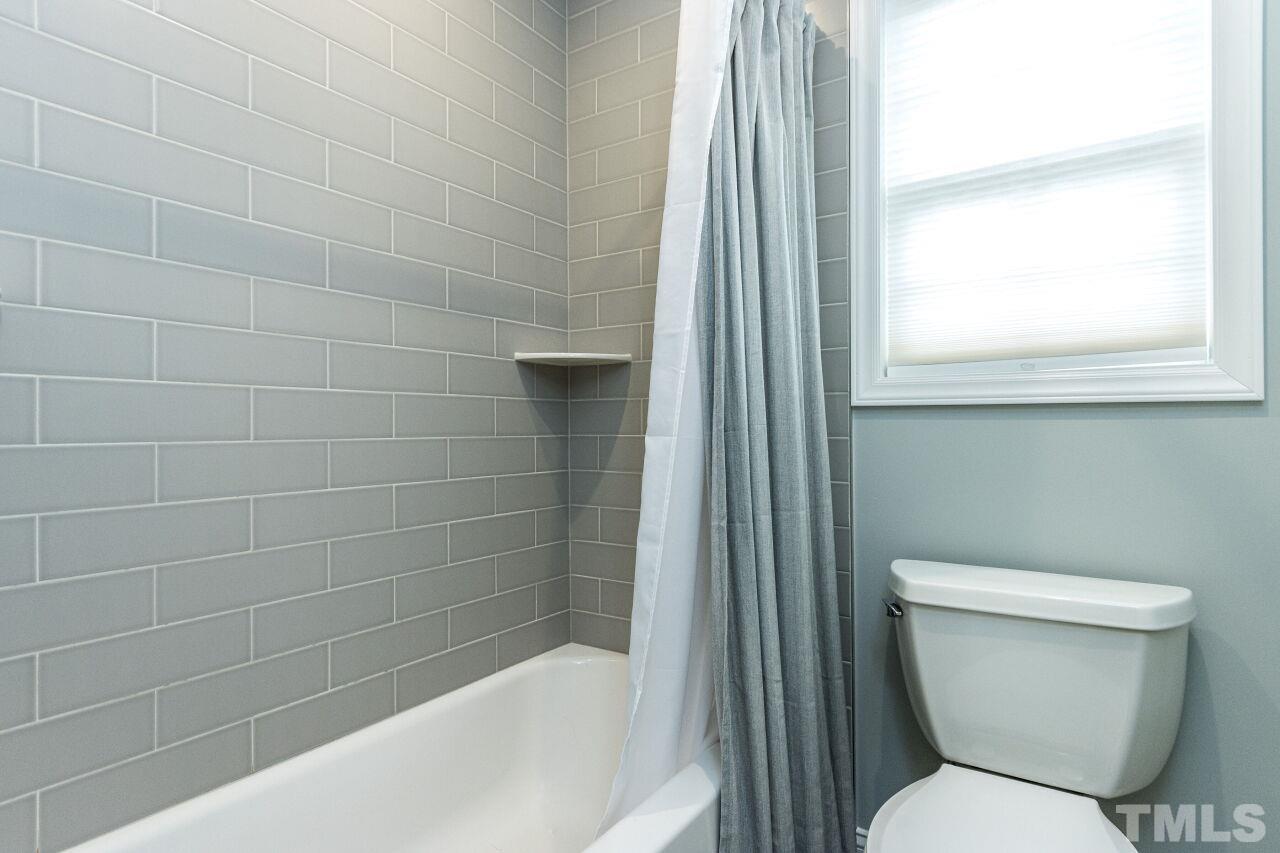 8215 Oneal Road Raleigh, NC 27613 - Photo 19 of 23 a bathroom with a toilet and bathtub