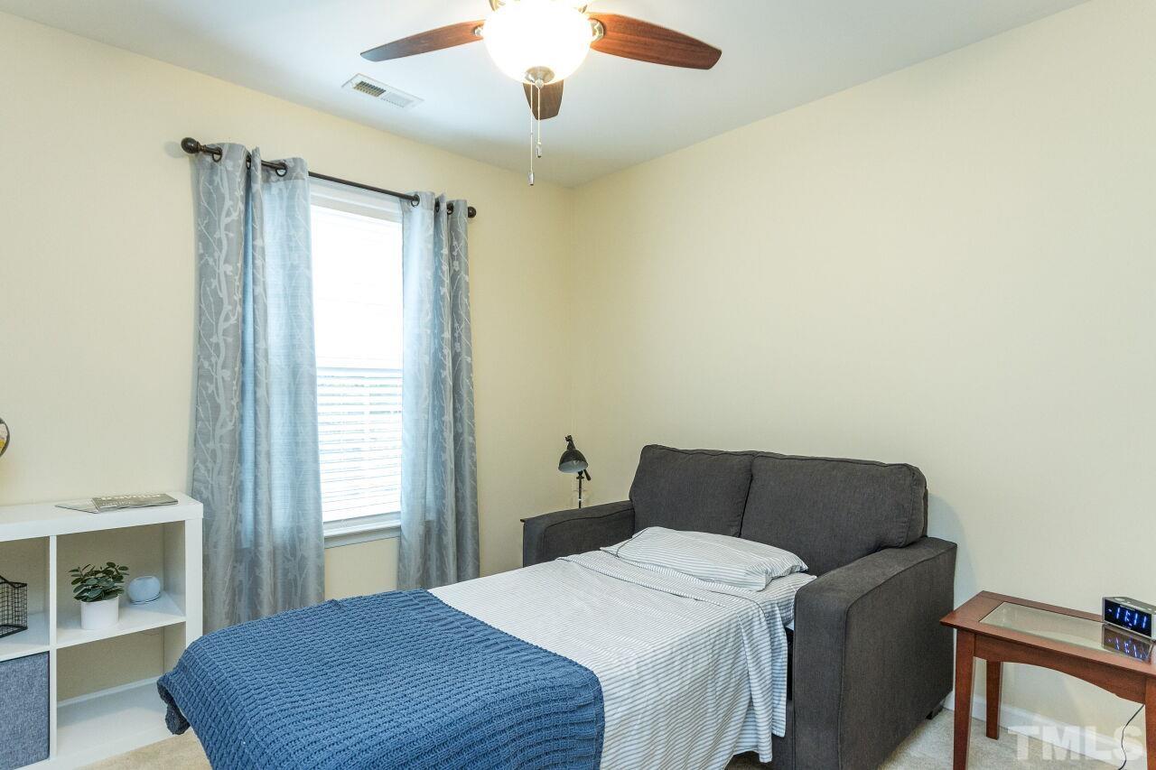 8215 Oneal Road Raleigh, NC 27613 - Photo 20 of 23 a bedroom with a bed and a window
