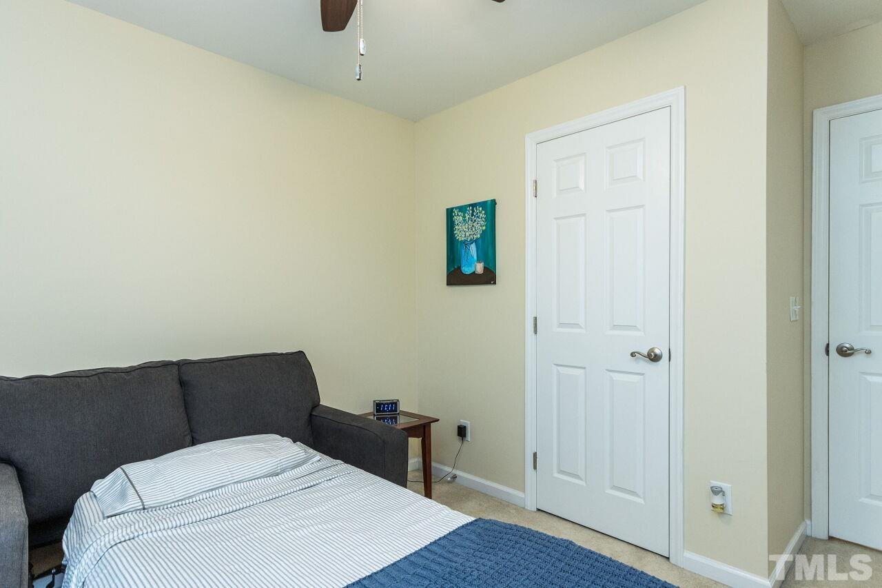 8215 Oneal Road Raleigh, NC 27613 - Photo 21 of 23 a hotel room with a bed and wooden floor