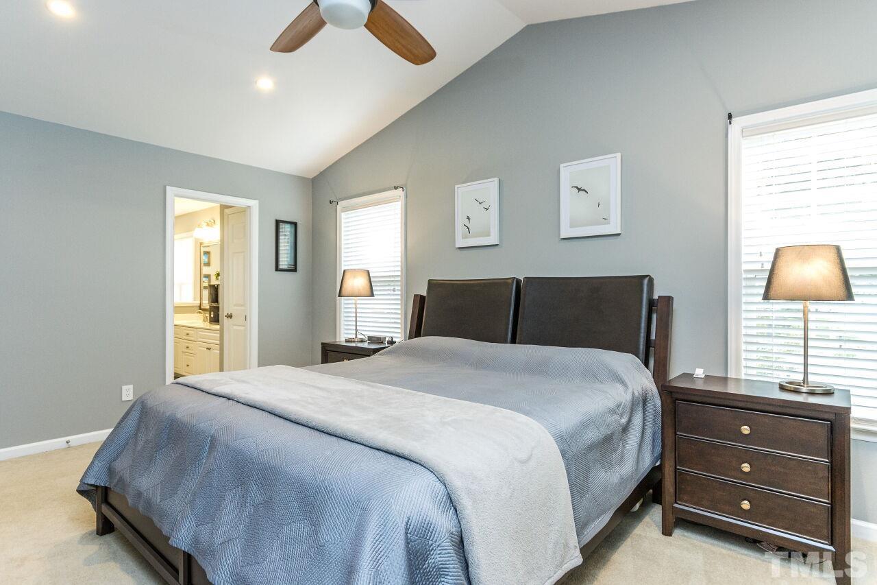 8215 Oneal Road Raleigh, NC 27613 - Photo 23 of 23 a bedroom with a bed and a flat tv screen on dresser