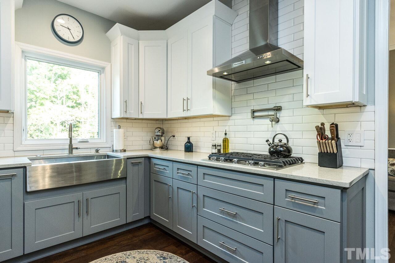 8215 Oneal Road Raleigh, NC 27613 - Photo 10 of 23 a kitchen with granite countertop white cabinets and white appliances