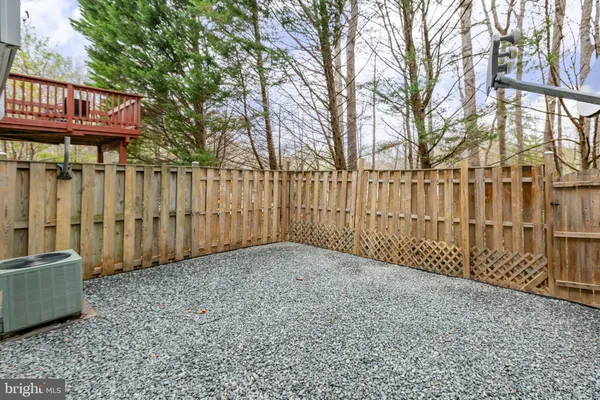 a view of a house with a wooden fence