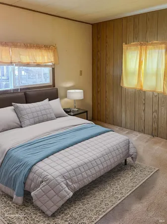 an empty room with closet and a window