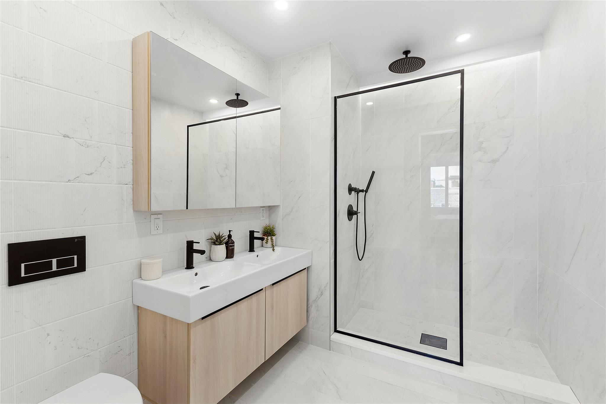 12-16 30th Avenue, Unit 201 Queens, NY 11102 - Photo 8 of 18 Full bath featuring a marble finish shower, double vanity, recessed lighting, and toilet