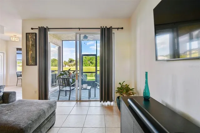 a living room with a large window and furniture