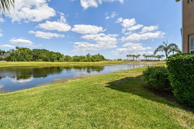 a view of a lake with houses in the back